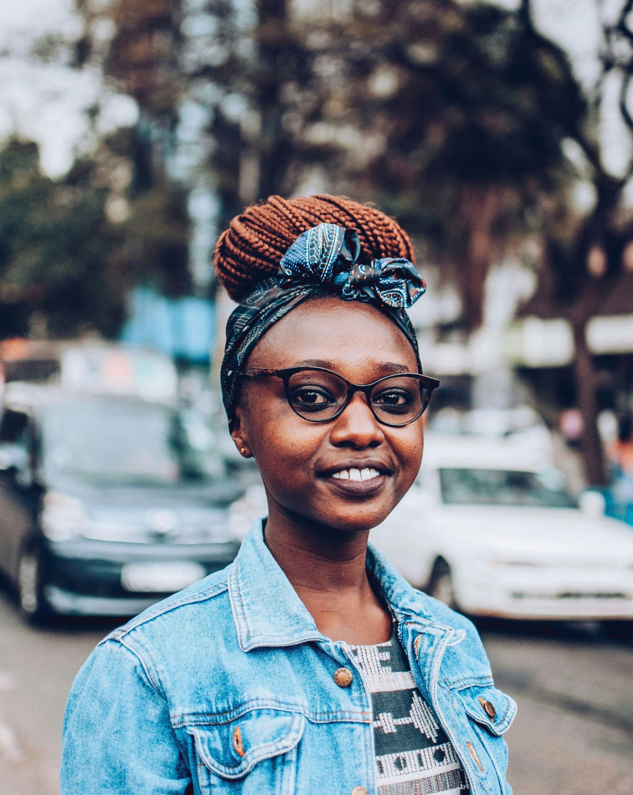 A joyful portrait of a stylish woman in Nairobi street, capturing her vibrant personality.